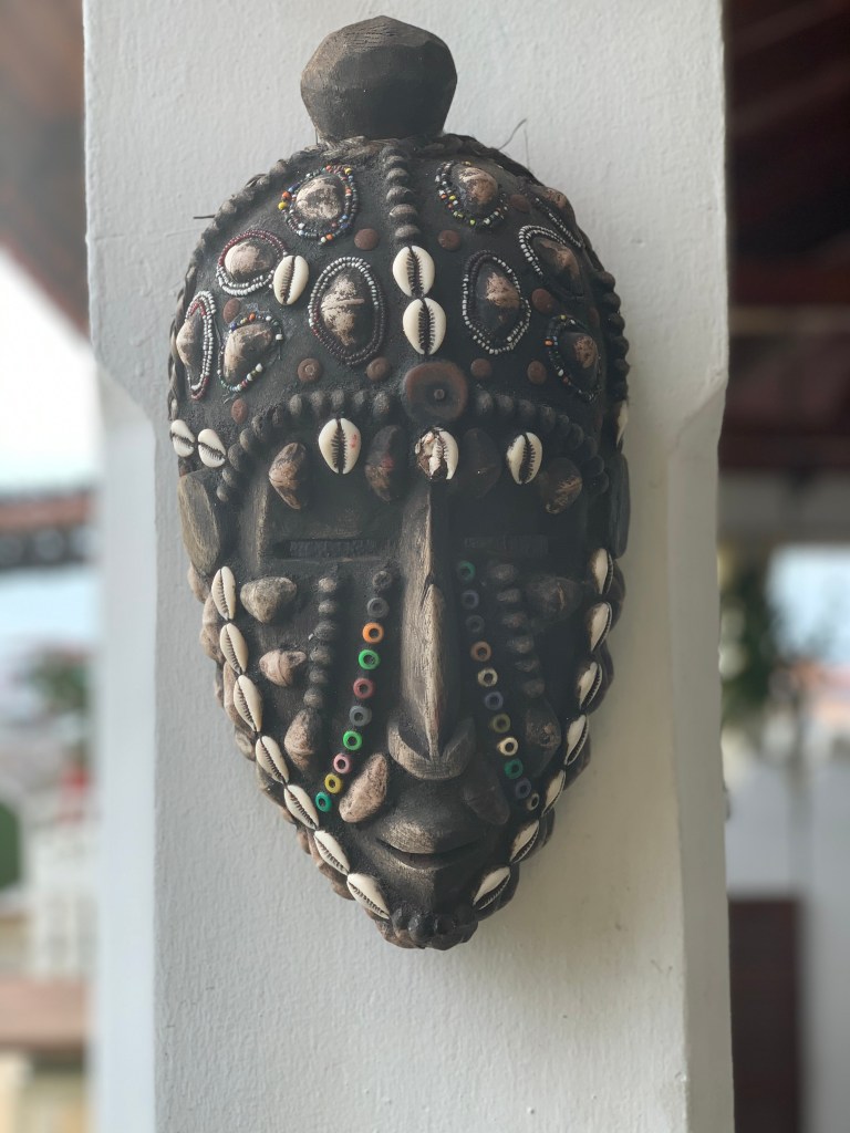 a traditional mask in swahili house in stone town, zanzibar, tanzania by sarah ambitious