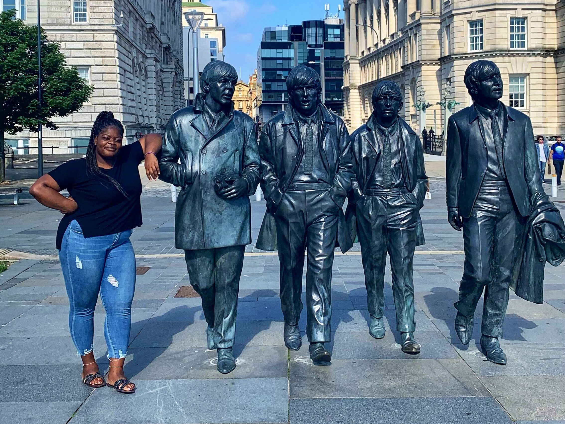 Sarah with the famous boy band 'The Beatles' in Liverpool, England